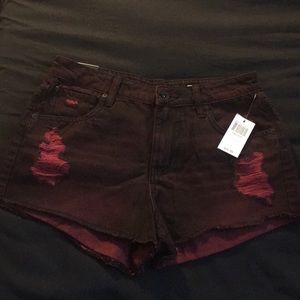Distressed red shorts.